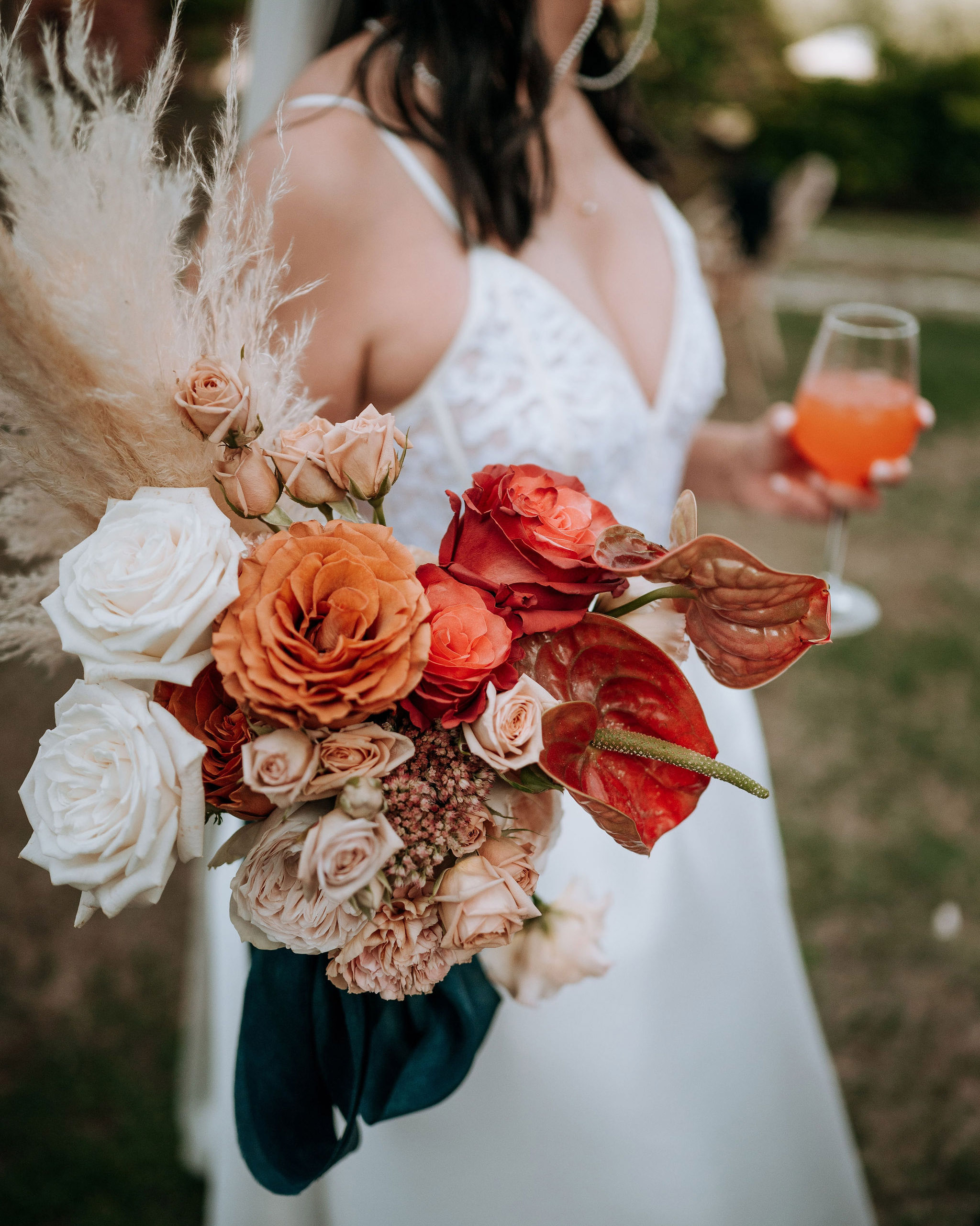 Bouquet da sposa sfumato dal crema al terracotta con pampas, rose e anthurium